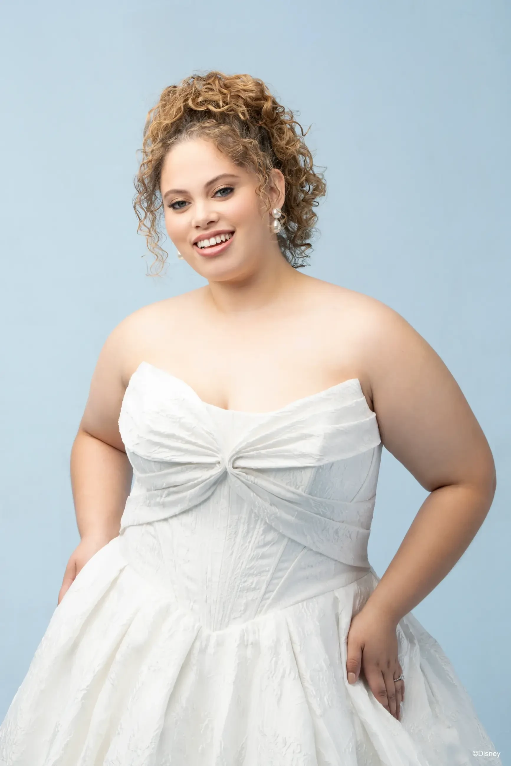 model is wearing a strapless basque waist wedding dress